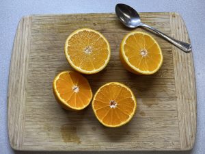 Navel and Sumo oranges, cut in half.