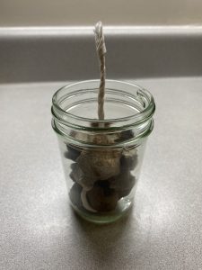 support the wick using rocks
